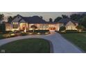 Stunning exterior with stone accents, manicured landscaping, and a circular driveway leading to a porte-cochère at 3795 Claybrook Ct, Bargersville, IN 46106