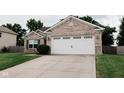 Photo shows a single-story home with a tidy lawn, concrete driveway and a two-car garage at 4233 Pearson Dr, Westfield, IN 46062