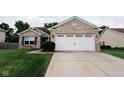 Quaint single-story home with a brick front, a concrete driveway, and a tidy lawn for curb appeal at 4233 Pearson Dr, Westfield, IN 46062