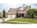 Traditional two-story brick home with a two-car garage and manicured lawn, presenting classic curb appeal at 47 Torrey Pine Dr, Brownsburg, IN 46112