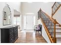 Elegant foyer with hardwood floors, staircase with iron railings, and arched doorways for a grand entrance at 47 Torrey Pine Dr, Brownsburg, IN 46112