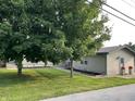 Exterior angle shot of home, showcasing manicured lawn and curb appeal at 52 S 16Th Ave, Beech Grove, IN 46107