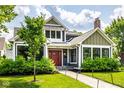 Charming two-story home featuring a well-maintained lawn, inviting walkway, and covered entry at 5425 N Delaware St, Indianapolis, IN 46220
