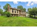 Attractive two-story home with brick accents, attached garage, and lush green lawn at 5847 Democracy Dr, Indianapolis, IN 46254