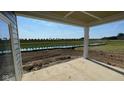 Covered patio overlooking a green lawn and water feature; offering a peaceful outdoor space for relaxation at 6367 Stone Side Dr, Plainfield, IN 46168