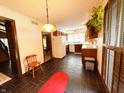This vintage kitchen features wooden cabinets, modern appliances, and dark tiling, with an adjacent dining area at 7038 E 65Th St, Indianapolis, IN 46256
