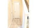 Hallway with stairs, tile floor, and two storage closets at 7906 States Bend Ln, Indianapolis, IN 46239