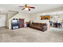 Spacious living room with neutral carpet, open layout, and seamless flow into the adjacent kitchen and dining area at 7906 States Bend Ln, Indianapolis, IN 46239