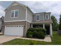 Charming two-story home featuring a two-car garage, brick accents, and a covered front porch at 8415 Fieldfare Way, Indianapolis, IN 46237