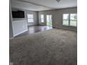 Spacious living room with carpet, hardwood floor, plenty of natural light, and open floor plan at 8415 Fieldfare Way, Indianapolis, IN 46237