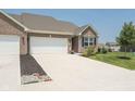 Beautiful home featuring a two-car garage, manicured landscaping, and a spacious driveway at 8842 Twain Ln, Indianapolis, IN 46239