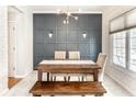 Bright dining room with gray accent wall, natural light, patterned wallpaper, and rustic wood table at 9740 Logan Ln, Fishers, IN 46037