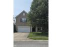 Two-story brick home with a front porch and attached garage, set on a sunny lot at 10523 Dark Star Dr, Indianapolis, IN 46234