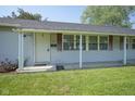Inviting entrance with a covered porch and well-kept lawn, providing great curb appeal at 11 Sayre Dr, Greenwood, IN 46143