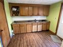 Kitchen with oak cabinets, a double-basin stainless steel sink and ample counter space at 1163 Groff Ave, Indianapolis, IN 46222