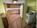 Kitchen with cabinets, appliances, and hardwood floors in need of upgrades at 1163 Groff Ave, Indianapolis, IN 46222