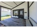 Inviting front porch with a bench and overhead protection from the elements at 12003 Broadway St, Indianapolis, IN 46236