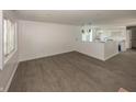 Spacious living room with wood-look floors that opens to the kitchen area at 12003 Broadway St, Indianapolis, IN 46236