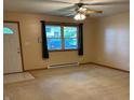 Inviting living room with lots of natural light and neutral carpet throughout the space at 1219 Lansdowne Rd, Indianapolis, IN 46234