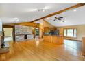Spacious living room with wood floors, stone fireplace, and ample natural light at 12196 N Beth Ann Dr, Camby, IN 46113