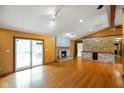 Cozy living room with stone fireplace and sliding glass doors to outdoor patio at 12196 N Beth Ann Dr, Camby, IN 46113