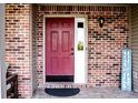 Covered front door with brick surround and decorative 'Home Sweet Home' sign at 1242 Flatrock Dr, Anderson, IN 46013
