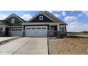 New construction home featuring a two-car garage, stone accents, and a modern, stylish design at 12532 Morning Ridge Way, Noblesville, IN 46060