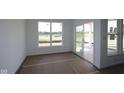 Bright room with large windows, sliding glass doors, and new construction finishes at 12532 Morning Ridge Way, Noblesville, IN 46060