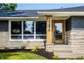 A closer view of the home's entrance, showcasing a stylish wooden door at 130 N High School Rd, Indianapolis, IN 46214