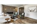 Bright living room with modern decor, fireplace and wood-look floors at 130 N High School Rd, Indianapolis, IN 46214