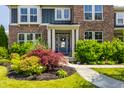 Inviting home entrance with beautiful landscaping, walkway and stylish front door at 16310 Nightshore Ln, Fishers, IN 46037