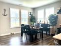 Formal dining room featuring hardwood floors and abundant natural light at 17324 Americana Xing, Noblesville, IN 46060