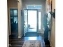Bright foyer with hardwood floors and a front door with transom window at 17324 Americana Crossing Xing, Noblesville, IN 46060