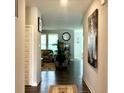 Inviting hallway showcasing hardwood floors leading to a spacious living room at 17324 Americana Crossing Xing, Noblesville, IN 46060