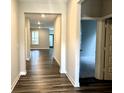 Inviting hallway features wood-look flooring and access to the living area, showcasing the home's open layout at 17324 Americana Xing, Noblesville, IN 46060