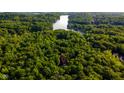 An aerial view of a wooded property with a nearby lake, showcasing its secluded location at 2034 Dynasty Ridge Rd, Martinsville, IN 46151