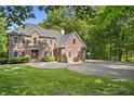 A beautiful two-story brick home with a well-maintained lawn and mature trees at 2034 Dynasty Ridge Rd, Martinsville, IN 46151