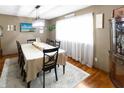 Dining room with hardwood floors, bright window, and a classic china cabinet at 227 Vestal Rd, Plainfield, IN 46168
