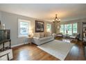 Bright living room with hardwood floors, neutral decor, and large windows offering plenty of natural light at 253 W Westfield Blvd, Indianapolis, IN 46208