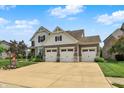 Beautiful home showcasing a three-car garage, well-maintained lawn, and inviting curb appeal at 2715 Benmore Ct, Zionsville, IN 46077