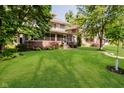 Inviting home with a spacious front yard, mature trees, and a classic screened-in porch, perfect for relaxing at 3246 N New Jersey St, Indianapolis, IN 46205