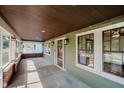 Covered porch featuring a wood ceiling, windows, and view of the neighborhood from the home's entrance at 3246 N New Jersey St, Indianapolis, IN 46205