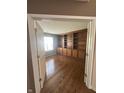 Spacious office with beautiful wood floors and a custom built-in bookshelf offering great storage space at 3350 Shore Dr, Greenwood, IN 46143