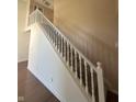 Classic white staircase connecting the levels of the home with carpeted steps and a light tan wall at 3350 Shore Dr, Greenwood, IN 46143