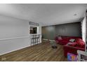Open-concept living room with hardwood floors and a bar area, perfect for entertaining and relaxation at 3509 N Wittfield St, Indianapolis, IN 46235