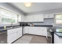Bright kitchen featuring modern appliances, ample countertop space, and white cabinets at 3740 Cheviot Pl, Indianapolis, IN 46205