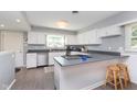 Bright kitchen with a breakfast bar, stainless steel appliances, and ample cabinet space at 3740 Cheviot Pl, Indianapolis, IN 46205