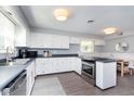 Bright kitchen with sleek countertops, stainless steel appliances, and modern white cabinetry at 3740 Cheviot Pl, Indianapolis, IN 46205