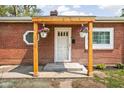 A cozy front porch with wooden support beams and hanging flower baskets at 4502 Evanston Ave, Indianapolis, IN 46205