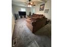 Spacious living room featuring plush carpeting, comfortable brown sofa, and bright window at 4744 E 33Rd St, Indianapolis, IN 46218